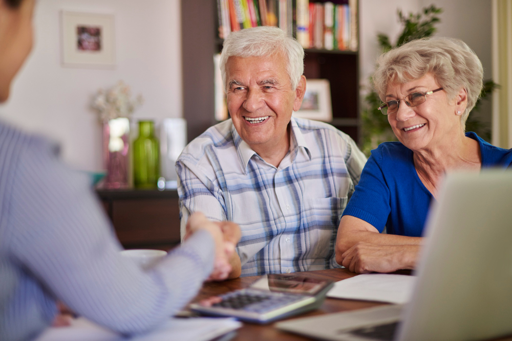Elderly couple going over finances with caregiver