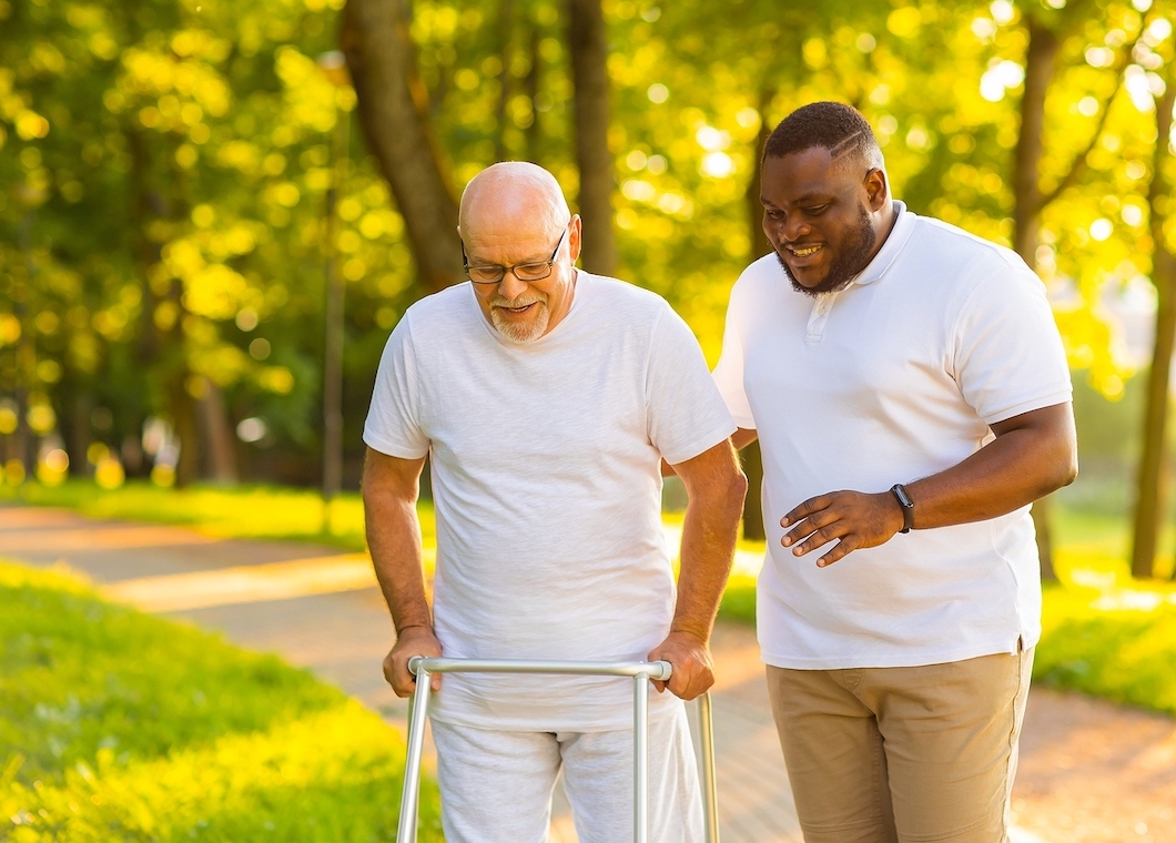 Caregiver walking with elderly man